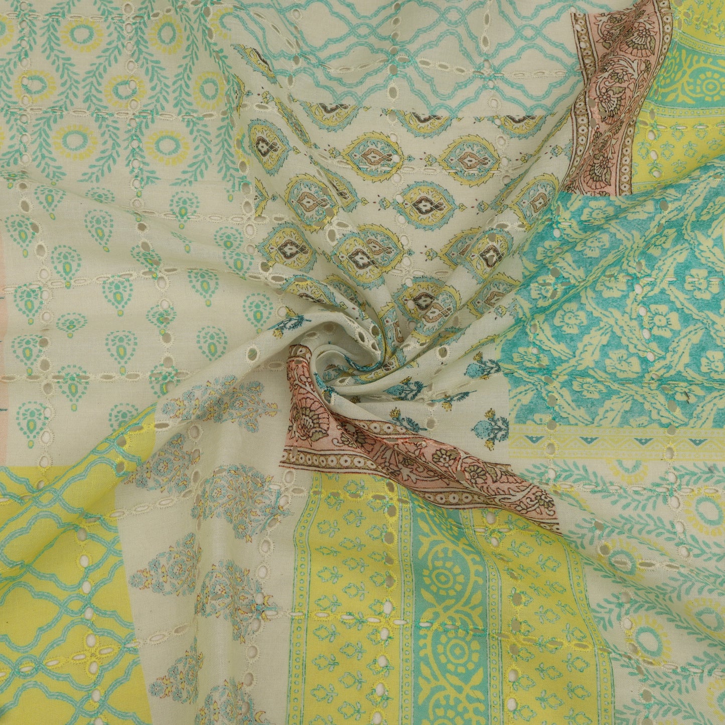 Colorful patterned fabric with a mix of green, yellow, and beige colors.