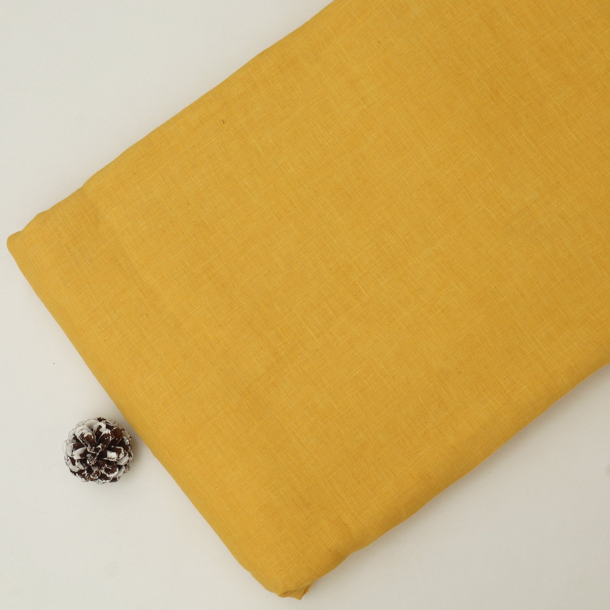 Mustard yellow fabric on a light gray background