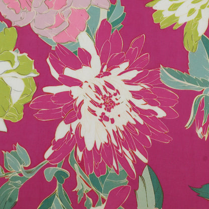 A close-up of a floral fabric pattern featuring a large magenta and white flower with green leaves on a deep pink background.