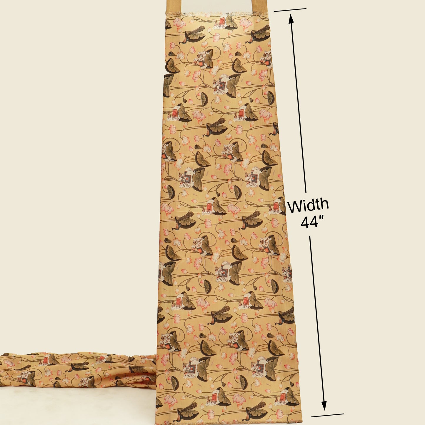 A beige apron with a repeating pattern of brown dogs on a floral vine background, shown with a folded matching apron at the bottom left and black measurement lines indicating a width of 44 inches.