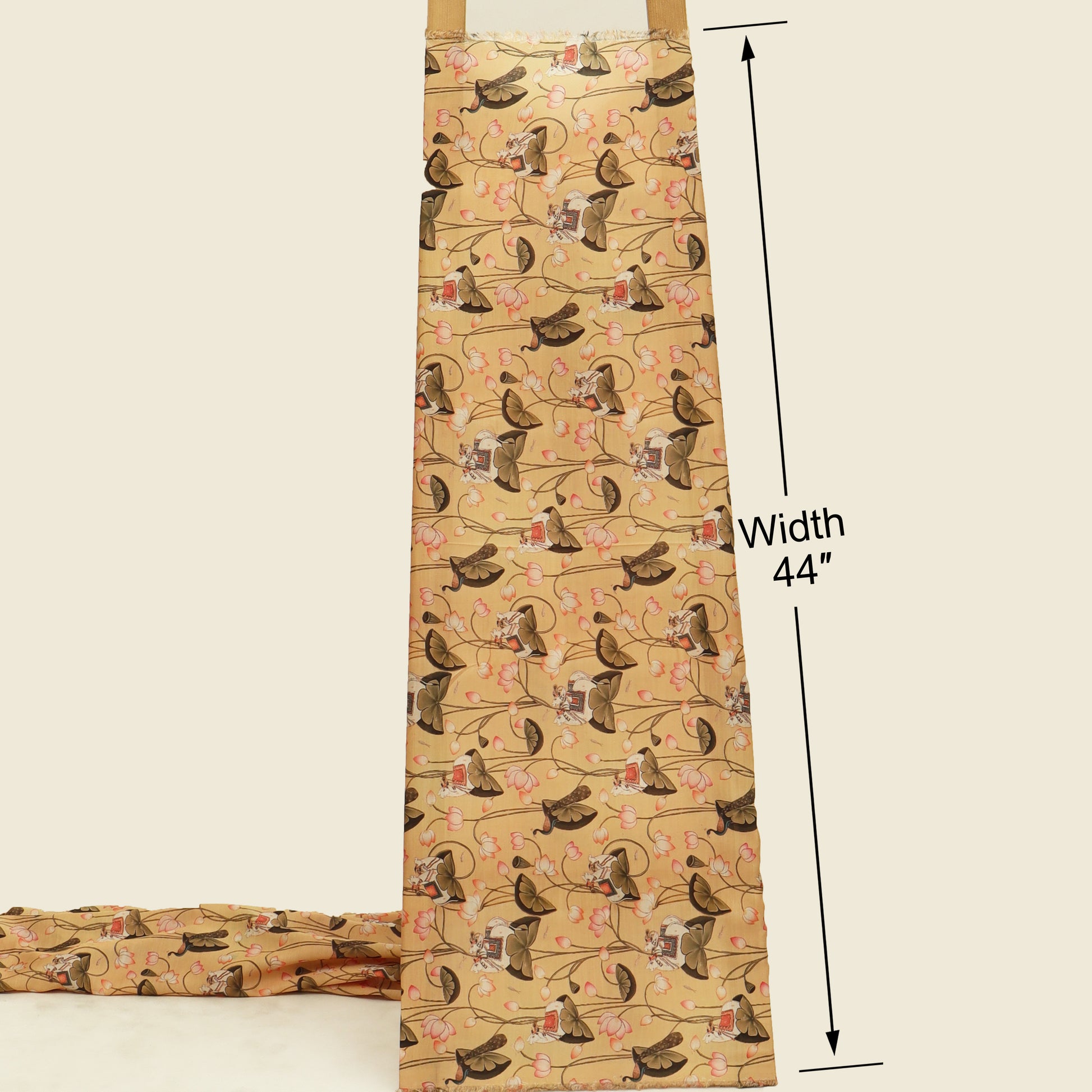 A beige apron with a repeating pattern of brown dogs on a floral vine background, shown with a folded matching apron at the bottom left and black measurement lines indicating a width of 44 inches.