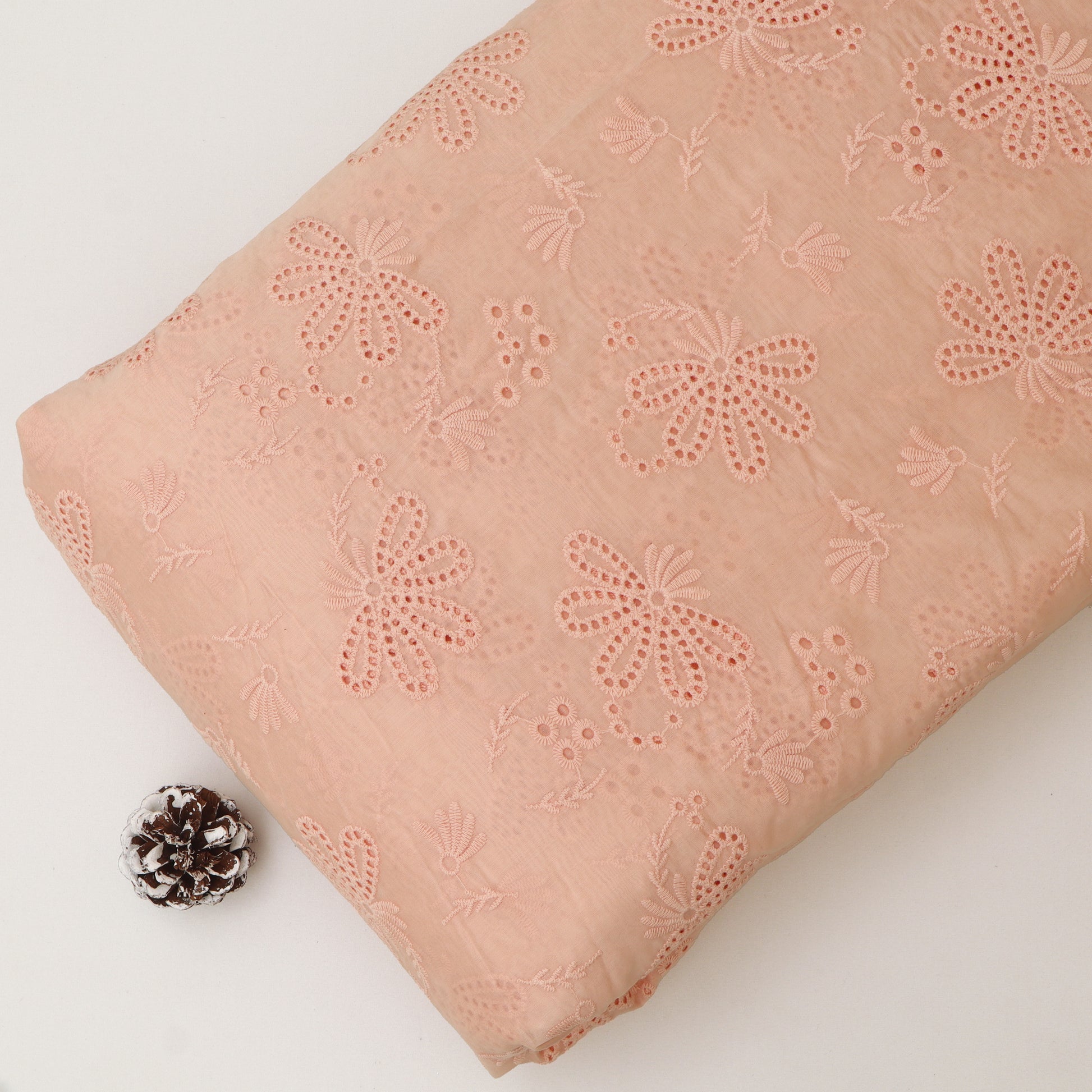 Pink lace fabric with floral patterns on a white background