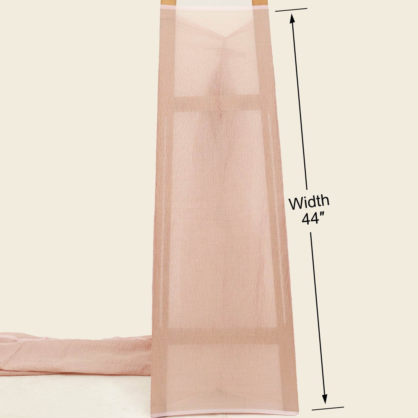 Beige fabric with a measurement label indicating width 44 inches on a beige background