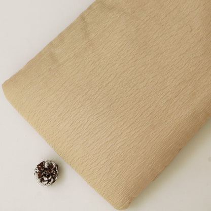Beige fabric with a pine cone on a light background