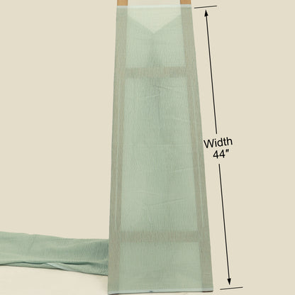 Light green fabric with a width measurement of 44 inches on a beige background