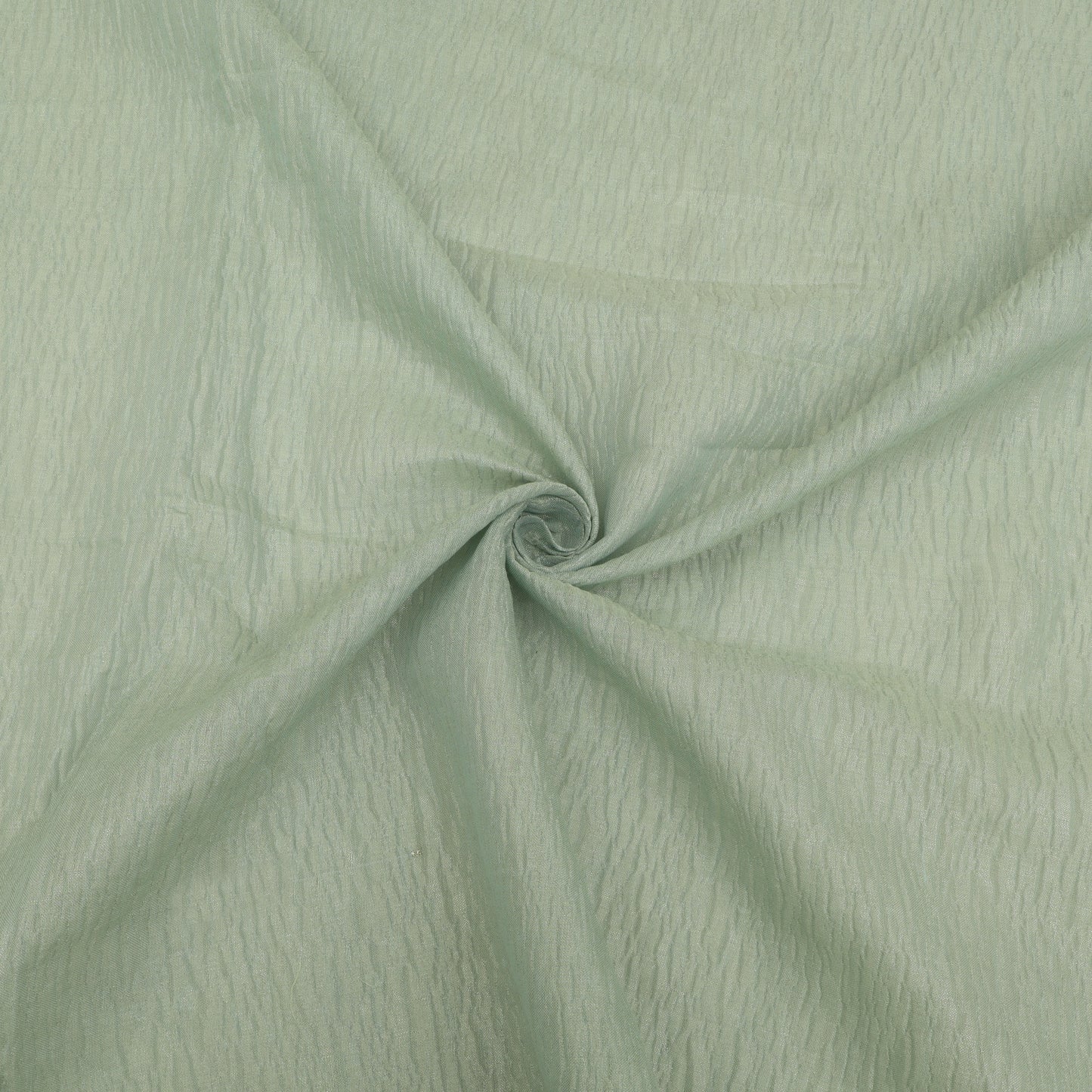 Close-up of light green fabric with a swirling pattern