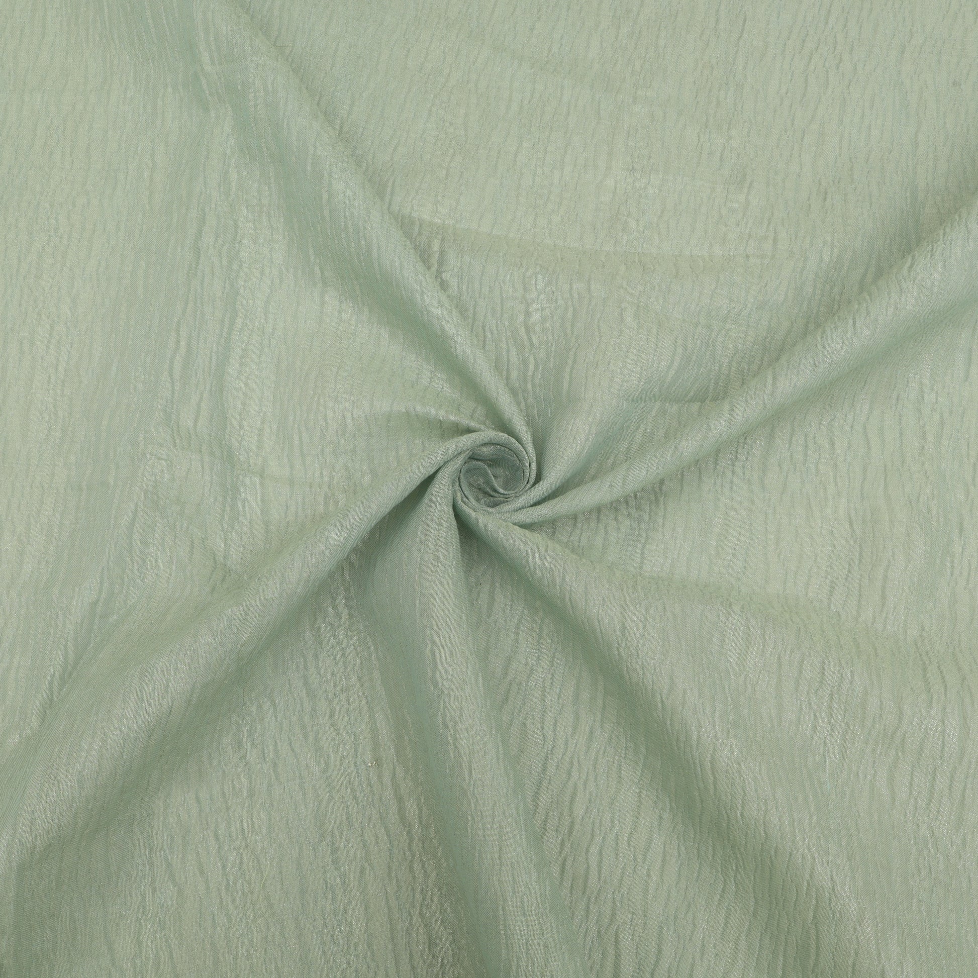 Close-up of light green fabric with a swirling pattern