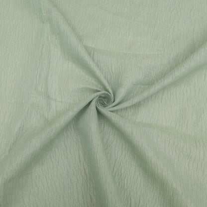 Close-up of light green fabric with a swirling pattern