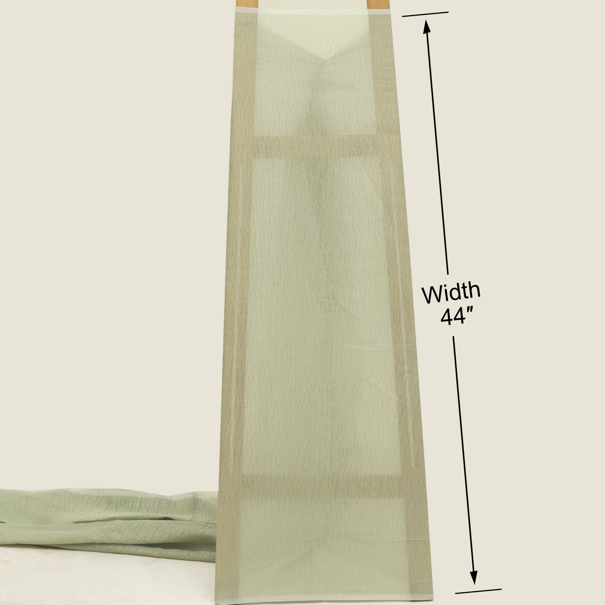 Green fabric with a measurement label indicating width 44 inches on a white background