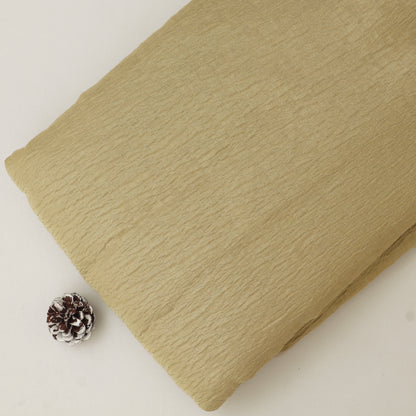Beige textured fabric with a pine cone on a light background