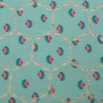 Patterned fabric with pink and green design on a teal background