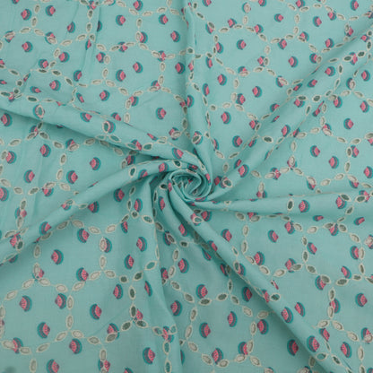 Turquoise fabric with small pink and green pattern