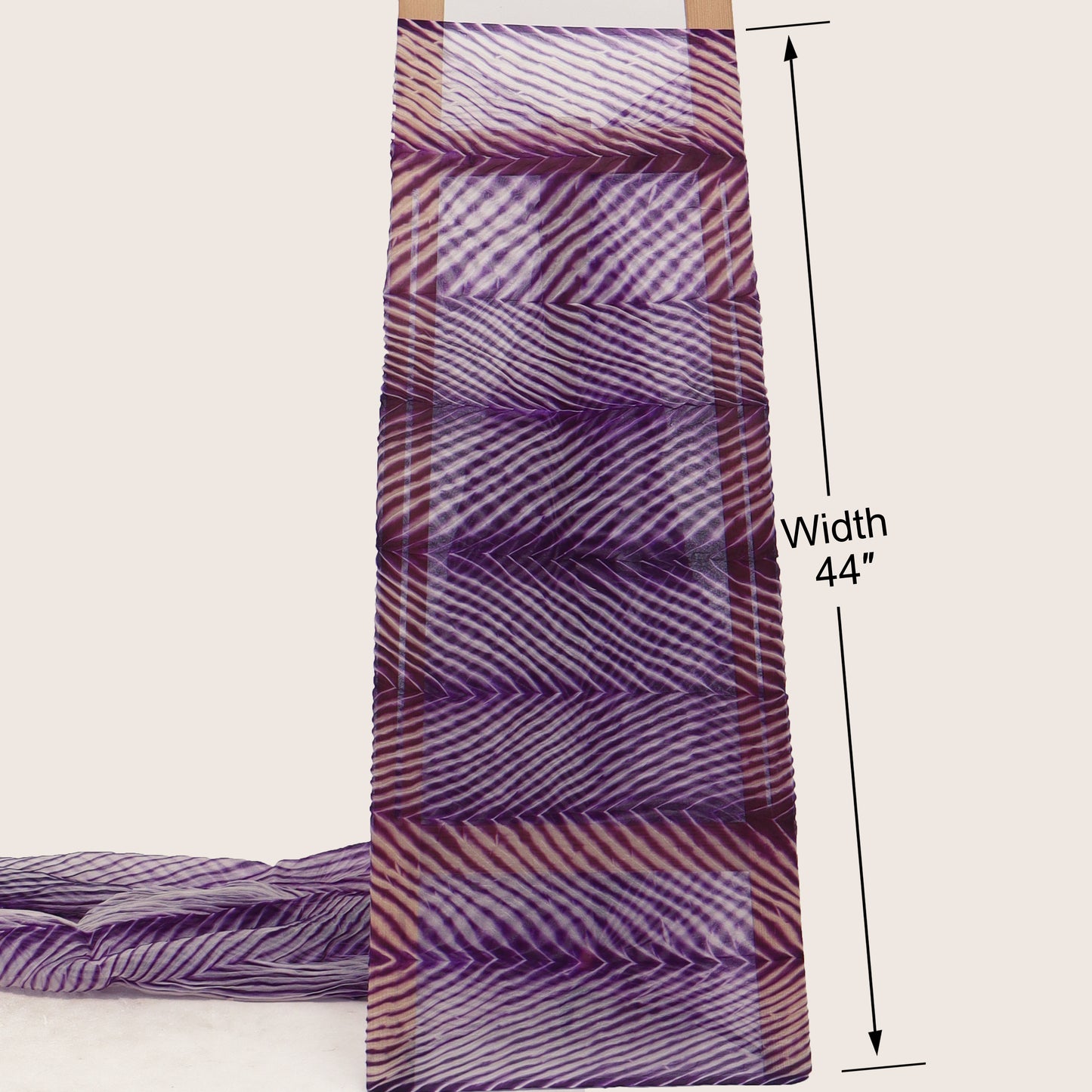 Purple and white patterned fabric with a width measurement of 44 inches on a beige background
