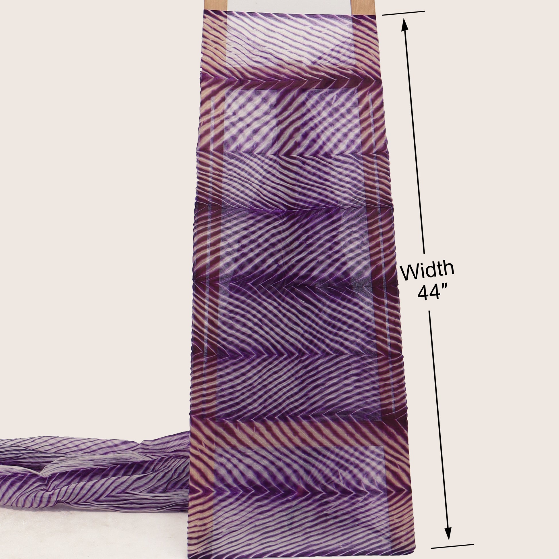 Purple and white patterned fabric with a width measurement of 44 inches on a beige background