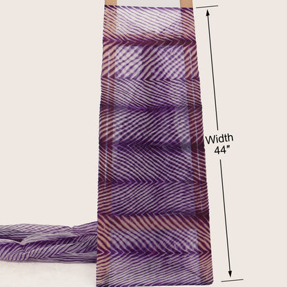 Purple and white patterned fabric with a width measurement of 44 inches on a beige background