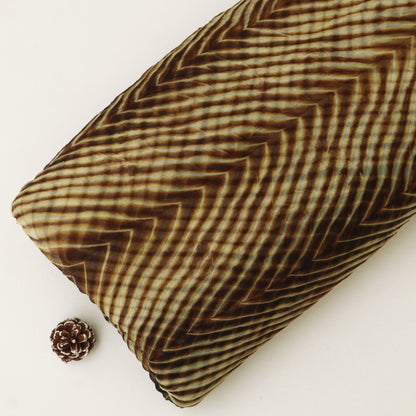 Textured brown pillow with a zigzag pattern on a white background