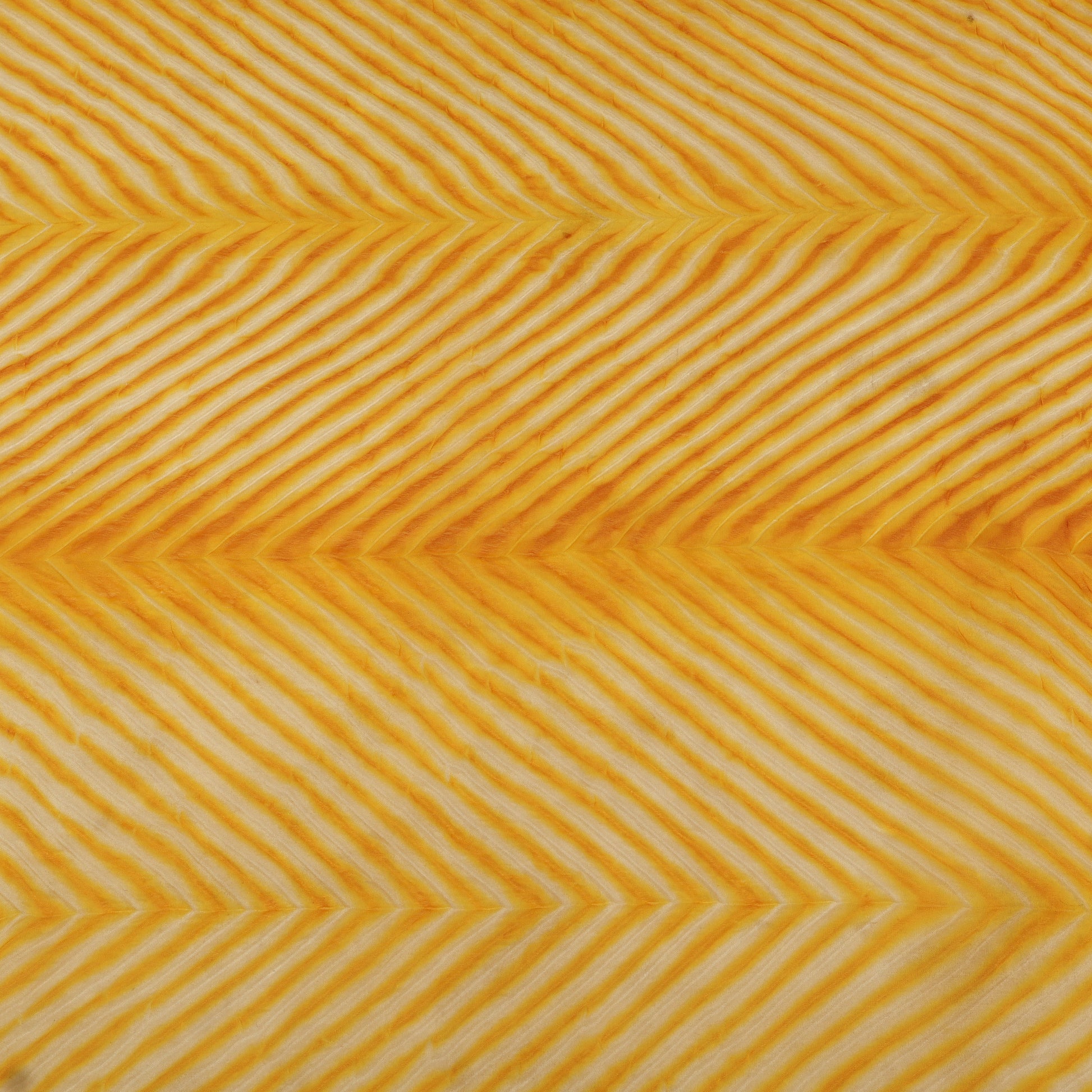 Pattern of yellow chevron lines on a textured background
