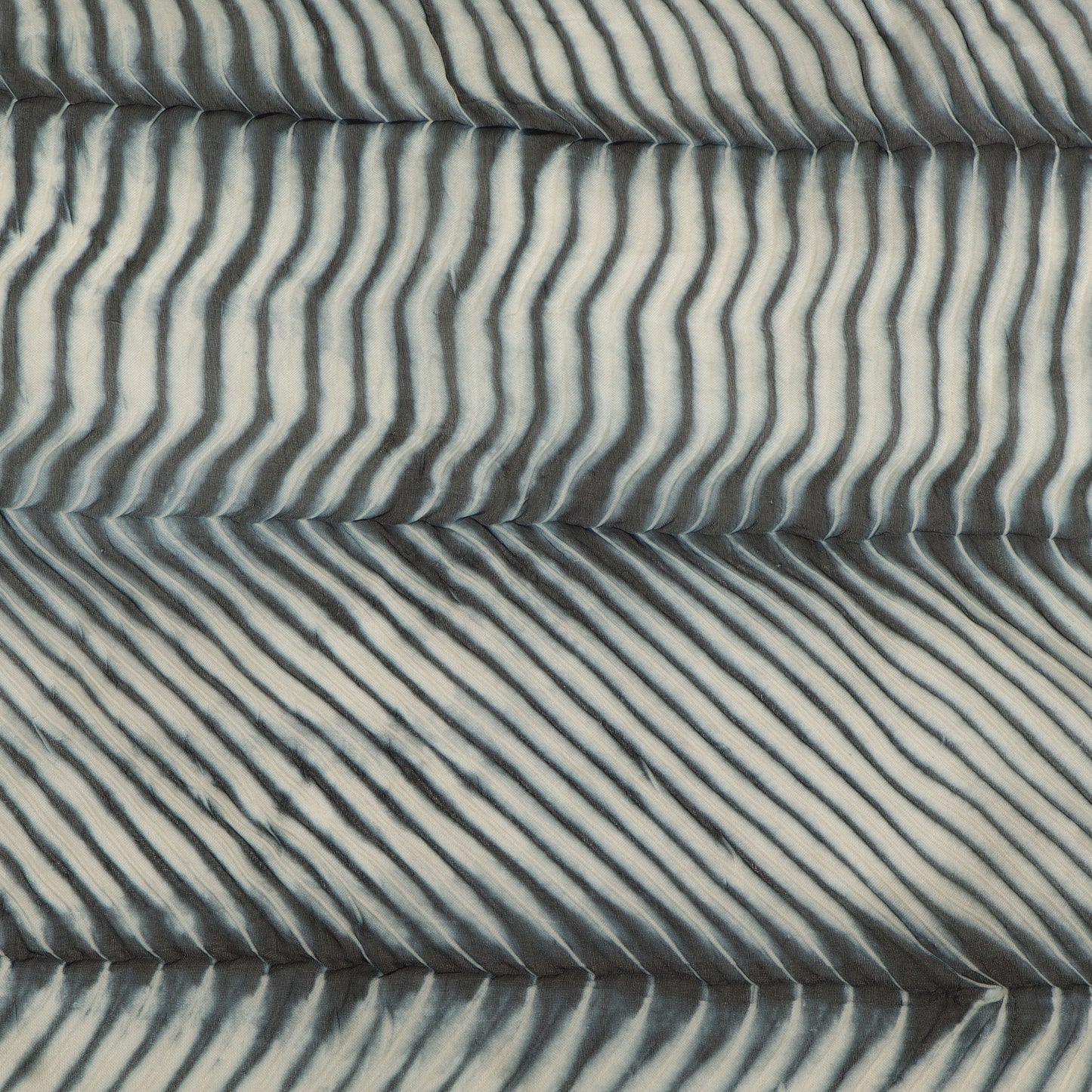 Textured fabric with wavy pattern in gray tones