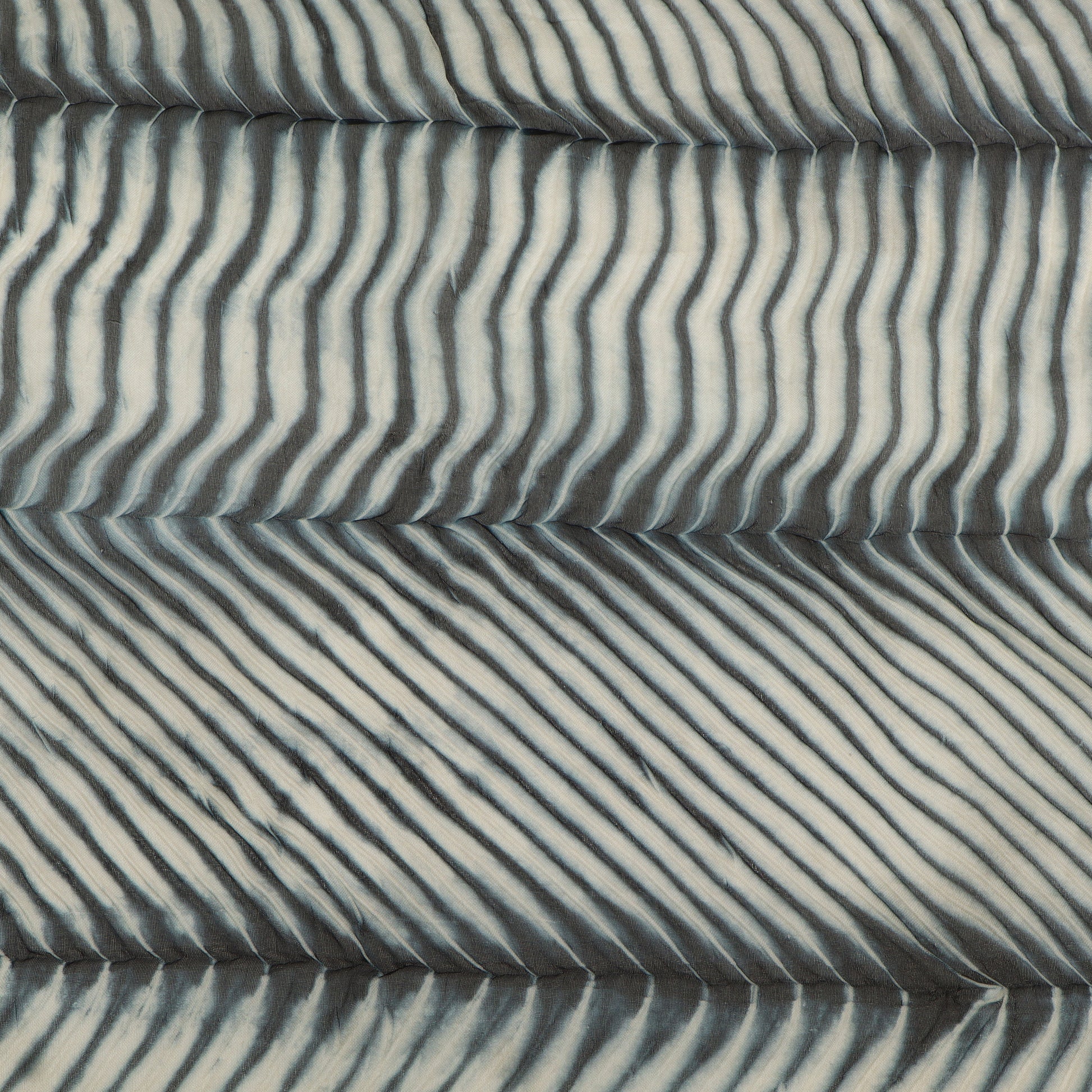 Textured fabric with wavy pattern in gray tones