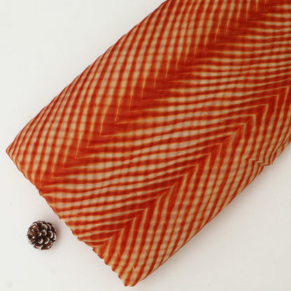 Red and white checkered fabric roll on a white background with a pine cone.