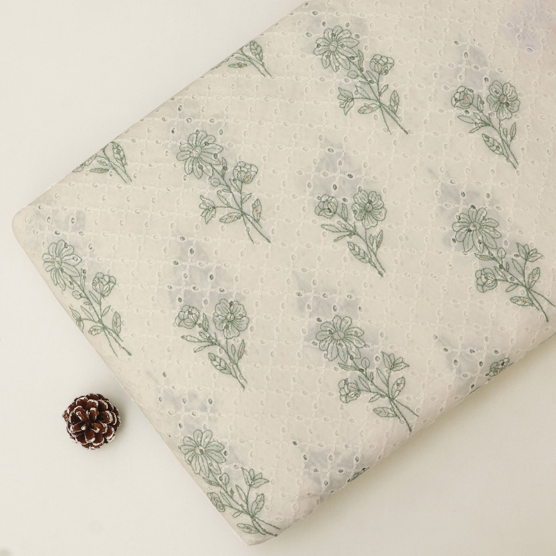Fabric with green floral pattern on a beige background