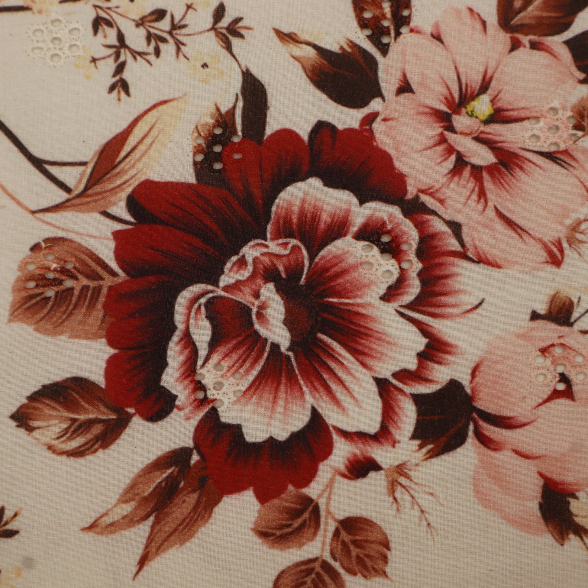 Close-up of a floral pattern with red and pink flowers on a beige background