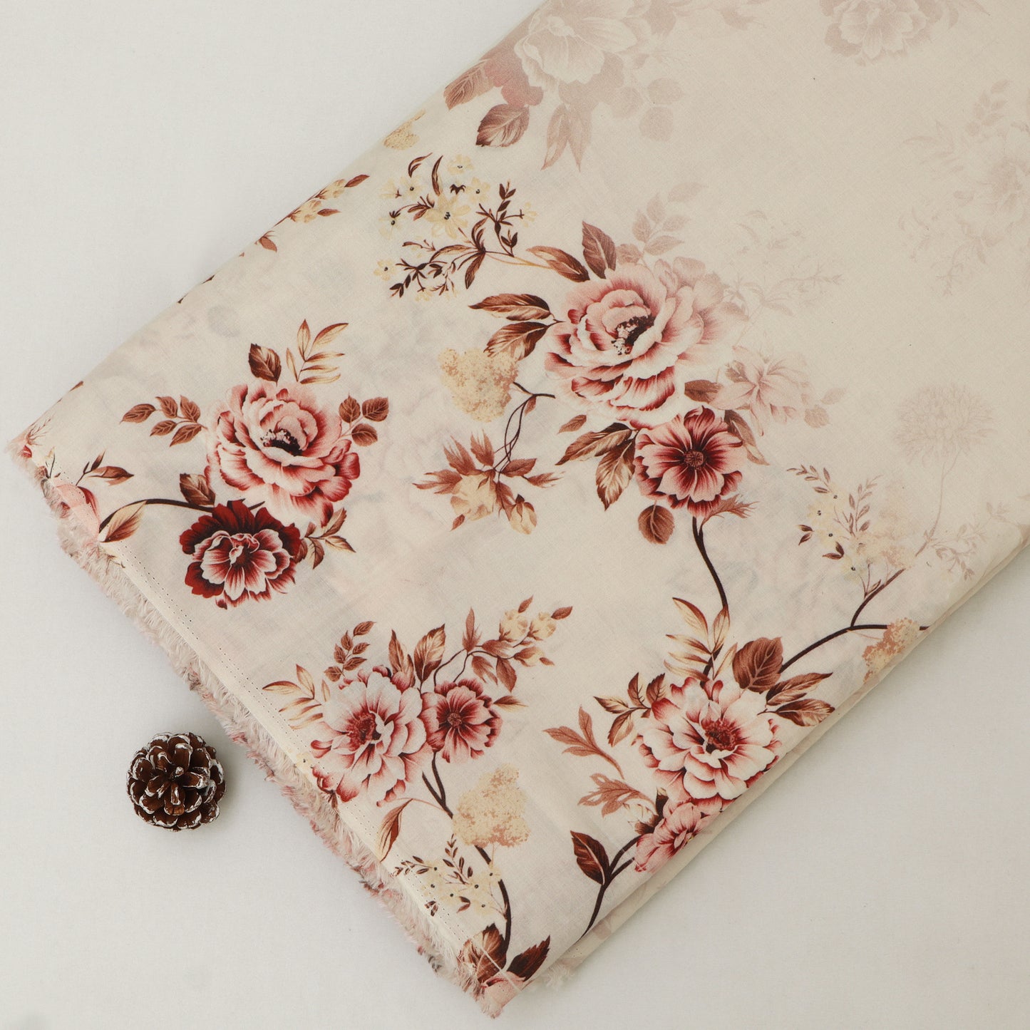 Floral-patterned fabric with pink and red flowers on a white background