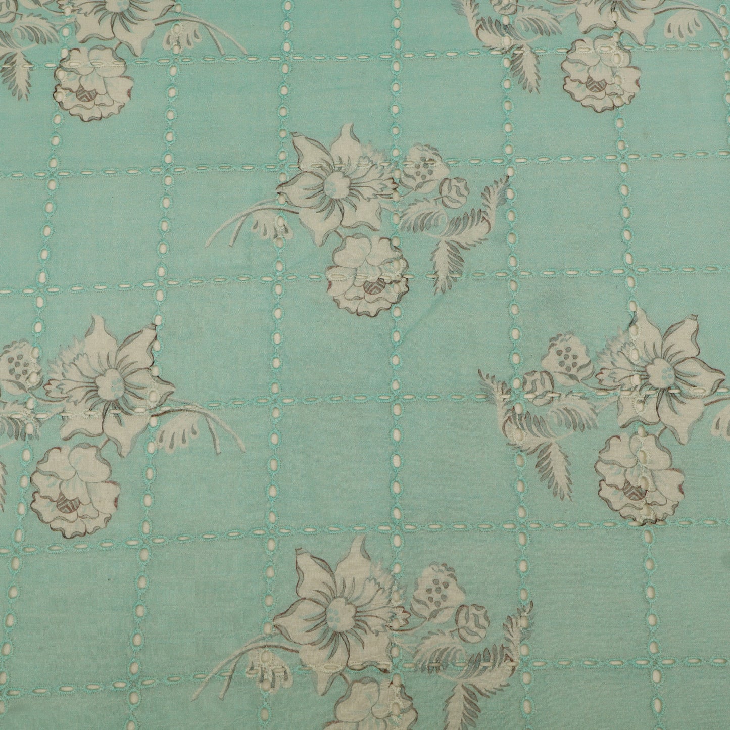 Floral pattern on a teal background with grid lines