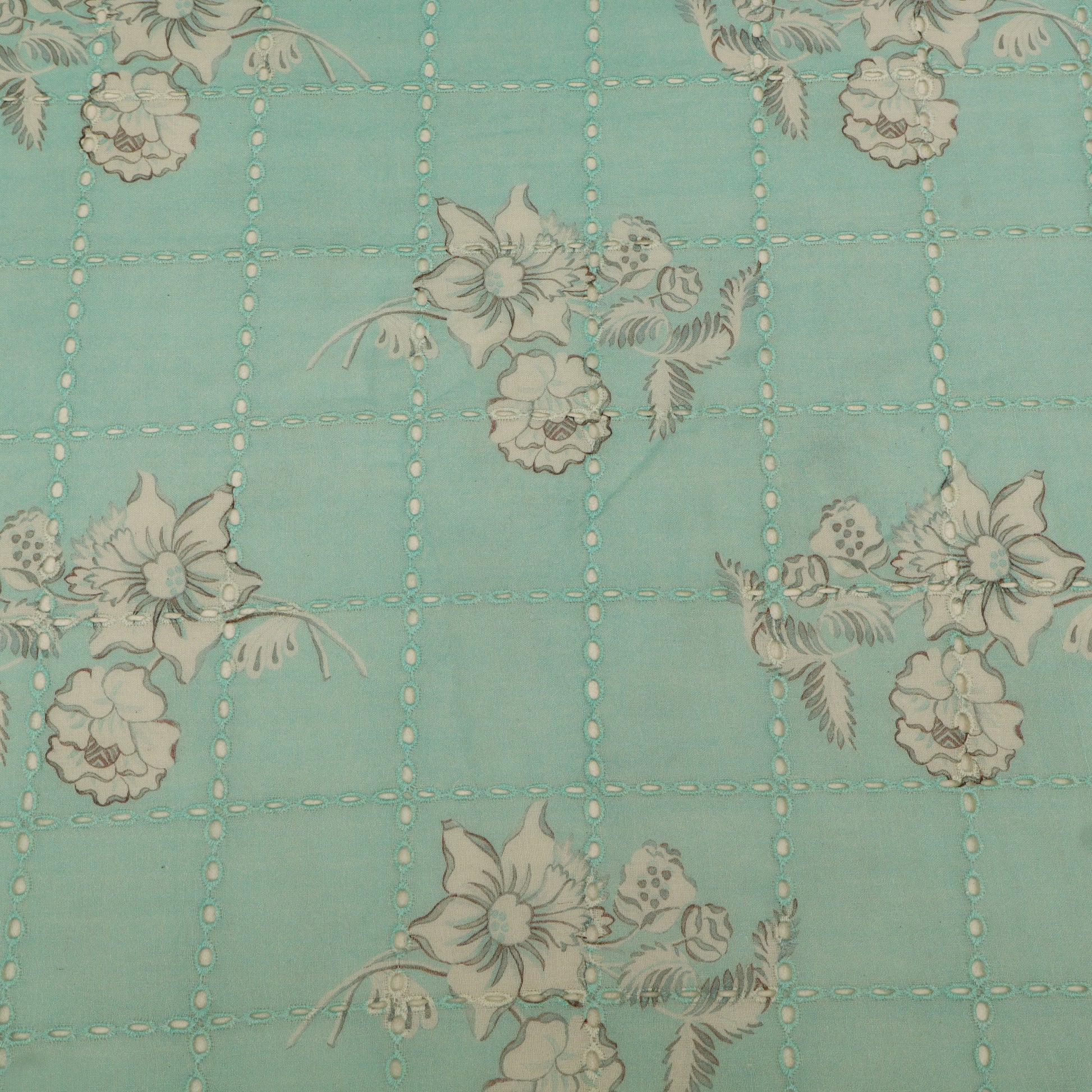 Floral pattern on a teal background with grid lines