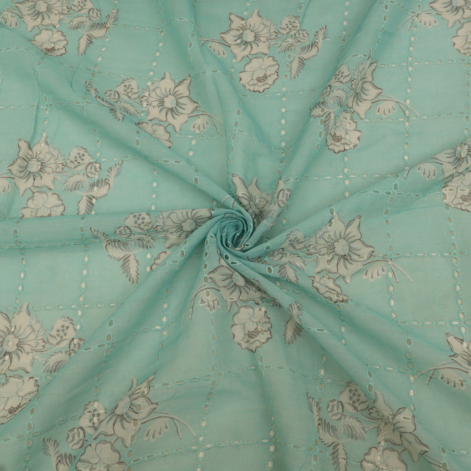 Teal fabric with floral pattern, folded in a way that creates a circular shape.