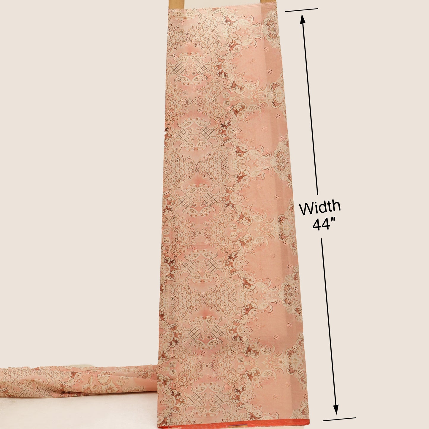 Pink floral patterned fabric with a width measurement of 44 inches on a beige background