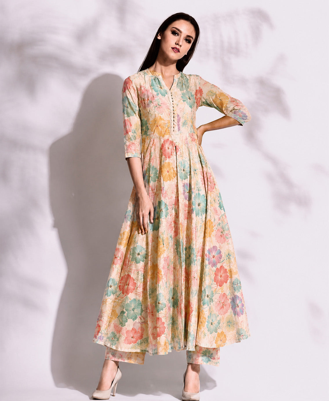 Woman wearing a floral dress against a white background