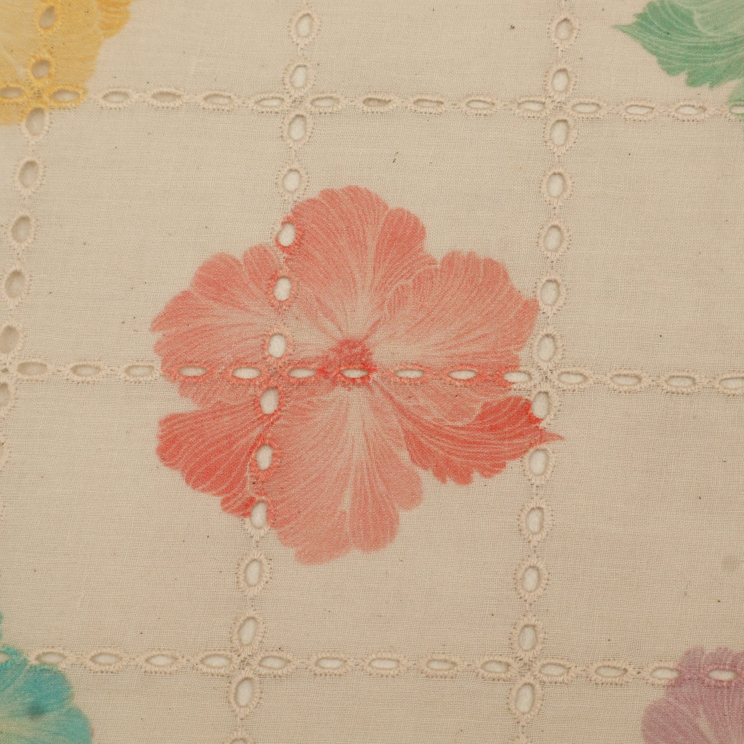 Close-up of floral patterned fabric with a red flower on a beige background