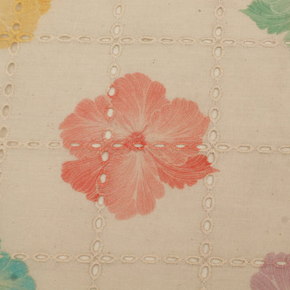 Close-up of floral patterned fabric with a red flower on a beige background