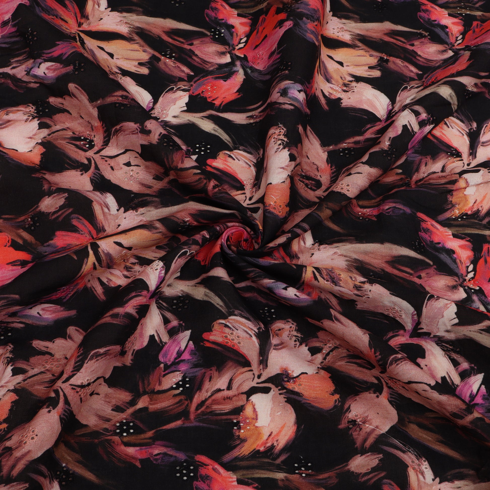 Close-up of floral fabric with pink, red, and black flowers on a dark background