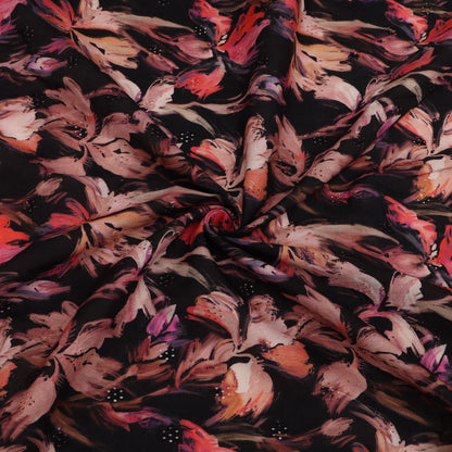 Close-up of floral fabric with pink, red, and black flowers on a dark background