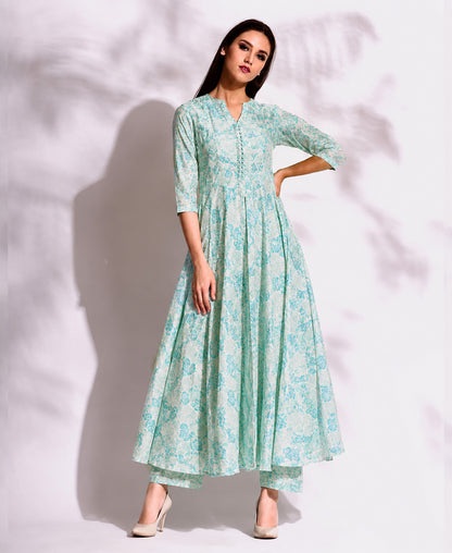 Woman wearing a light blue floral dress against a white background