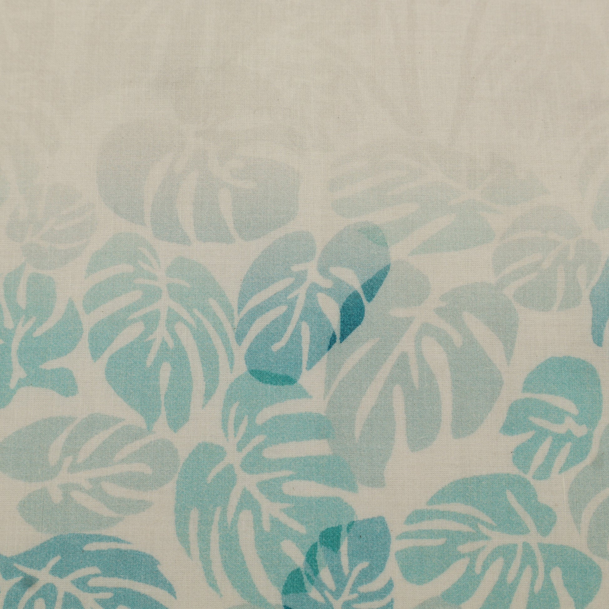 Pattern of blue leaves on a beige background