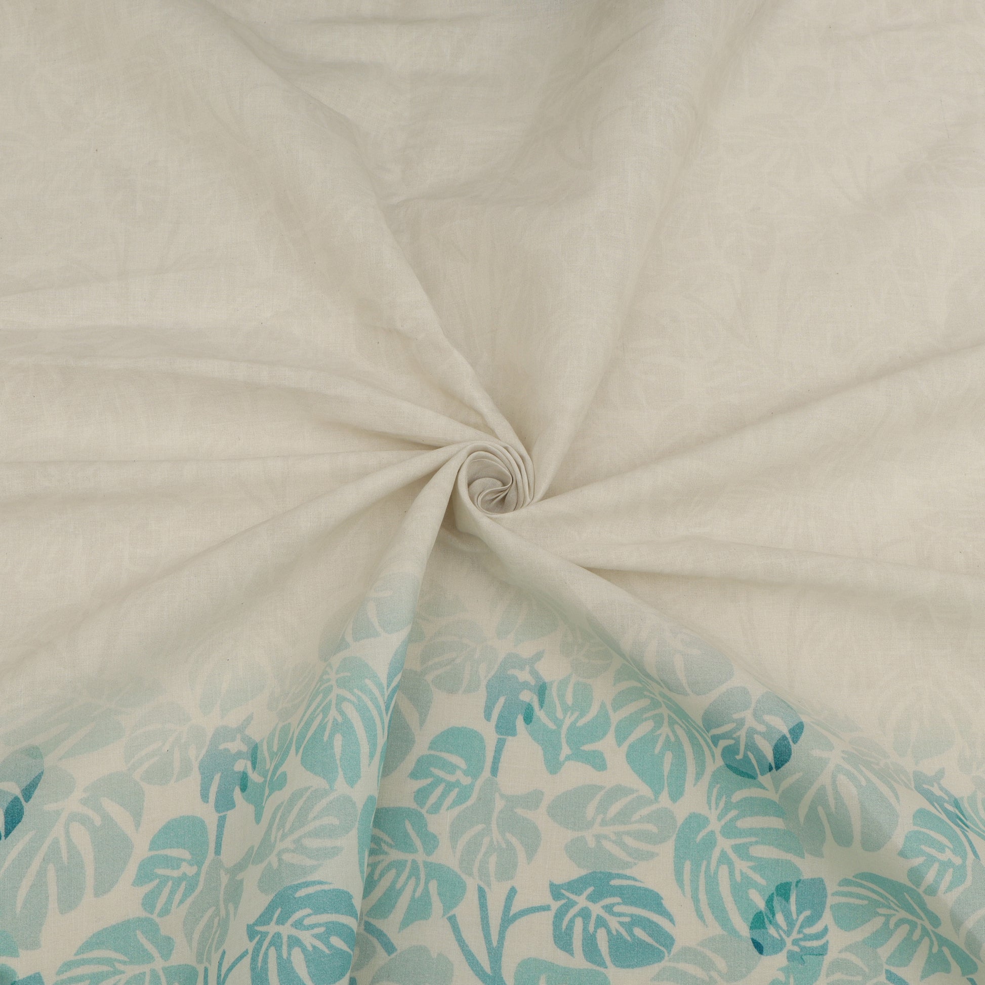 Close-up of beige fabric with a turquoise leaf pattern