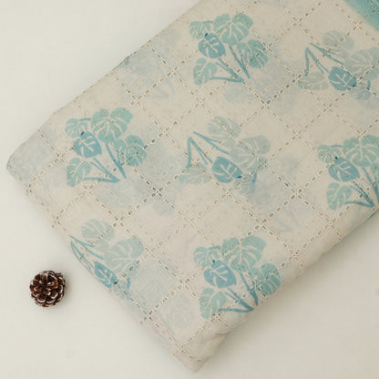 Floral-patterned fabric with a pine cone on a light background
