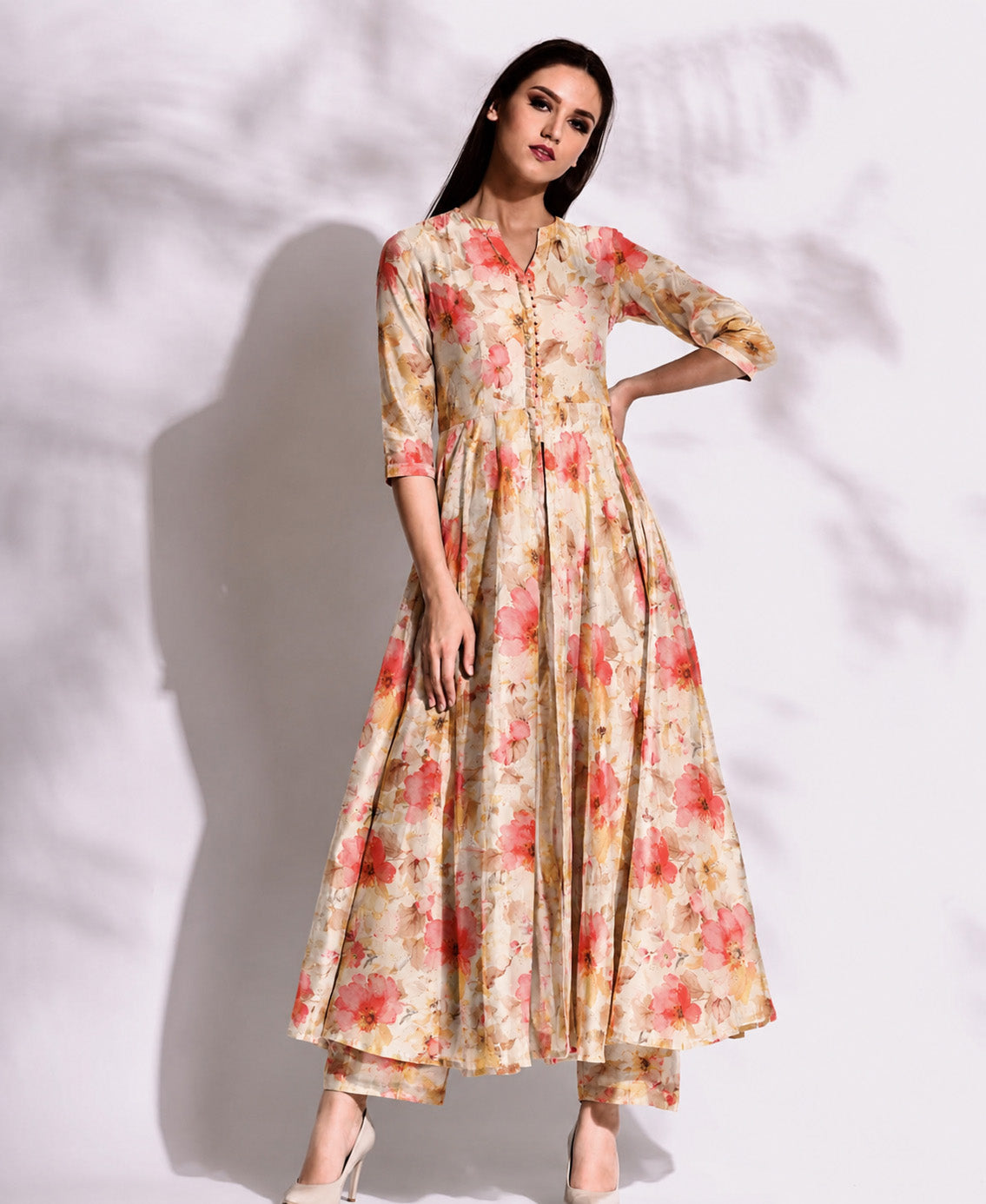 Woman wearing a floral dress against a white background