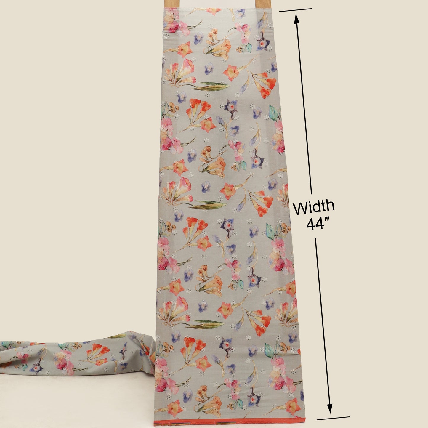 Floral-patterned fabric with a measurement label indicating width 44 inches on a beige background.