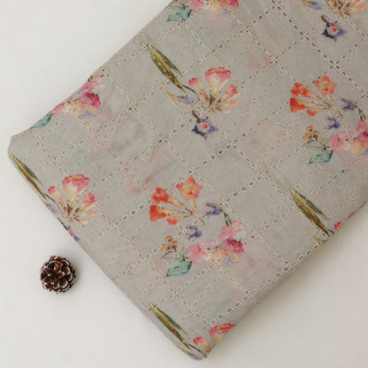 Floral-patterned fabric on a white background with a pine cone