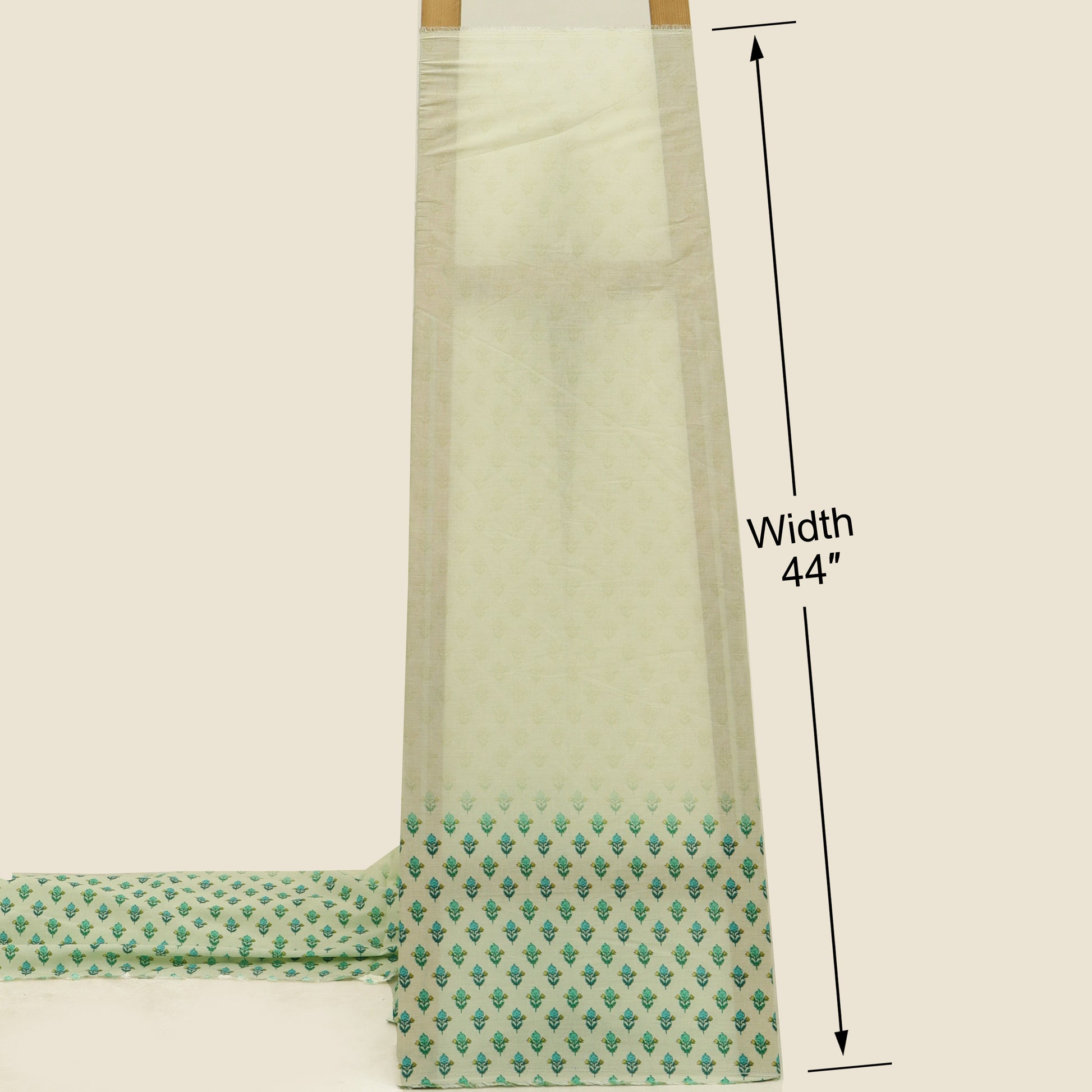 Green fabric with a pattern and measurement details on a beige background