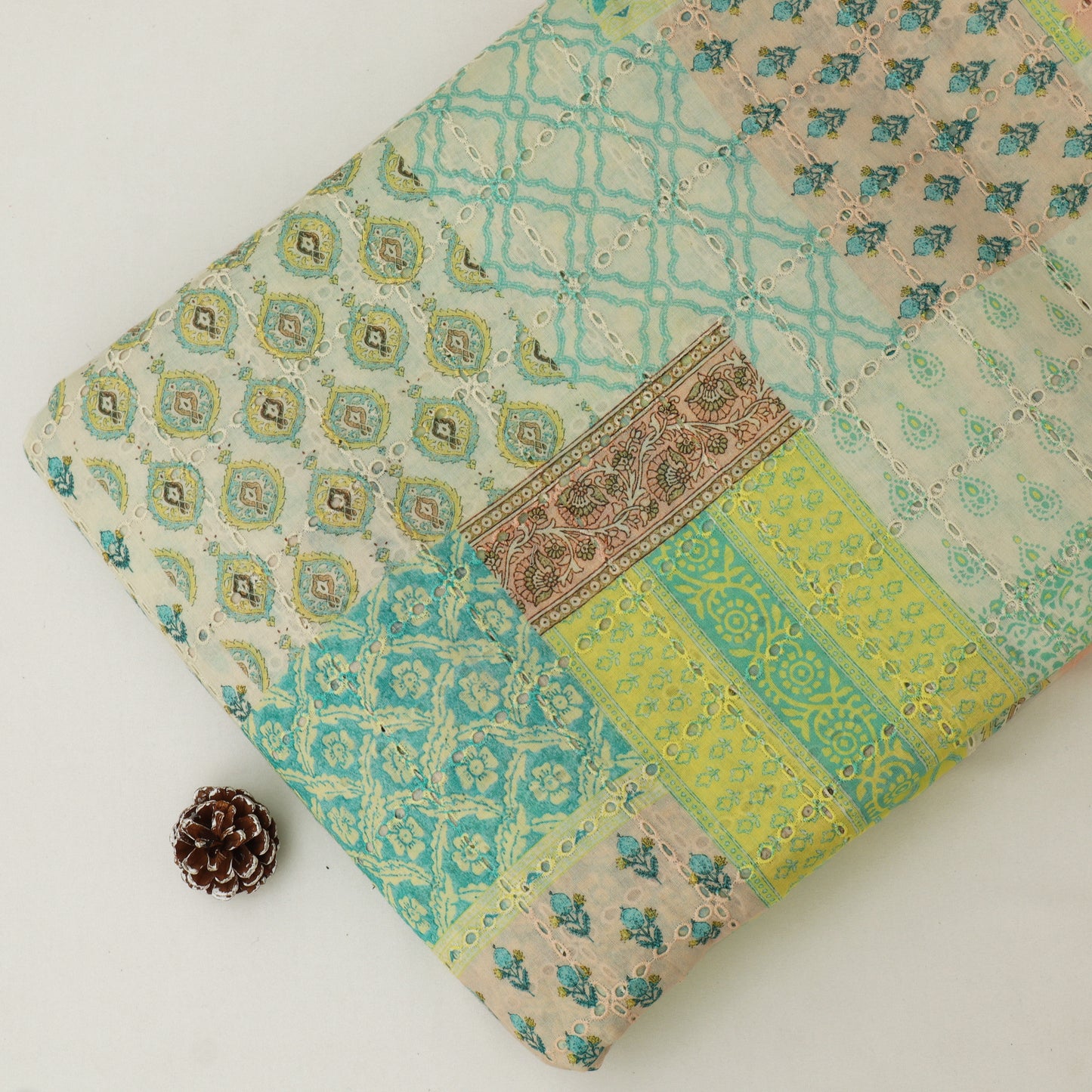 Patchwork fabric with geometric and floral patterns on a white background