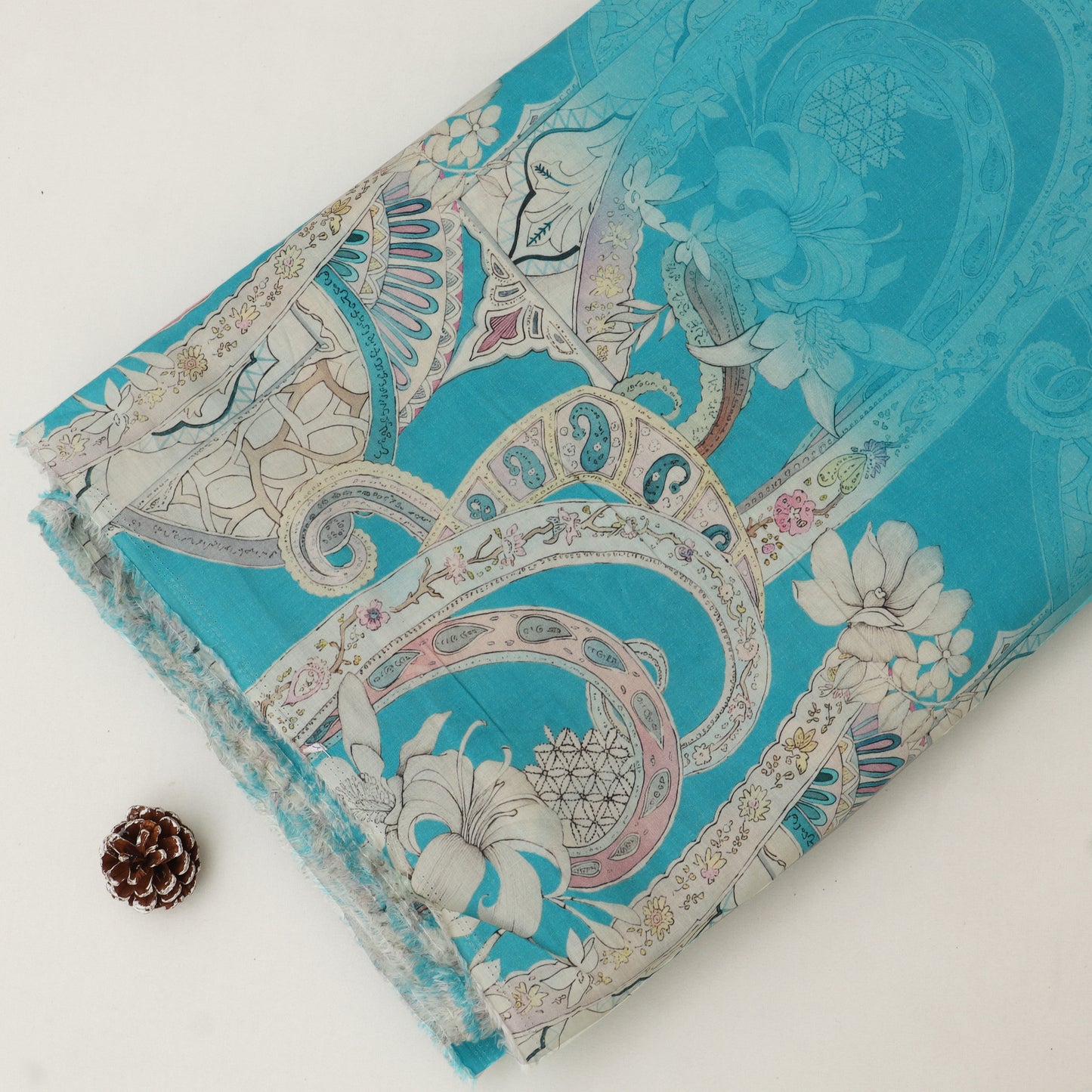 Decorative fabric with intricate paisley pattern on a white background