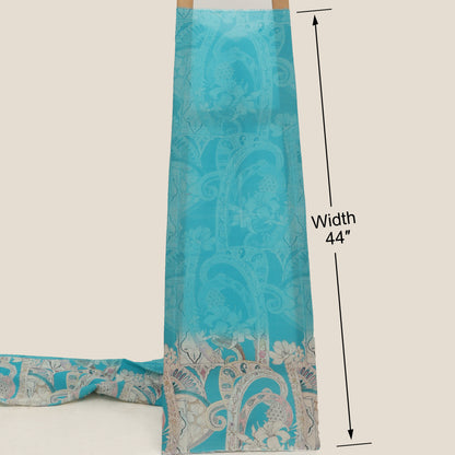 Turquoise fabric with paisley pattern and measurement label on a beige background