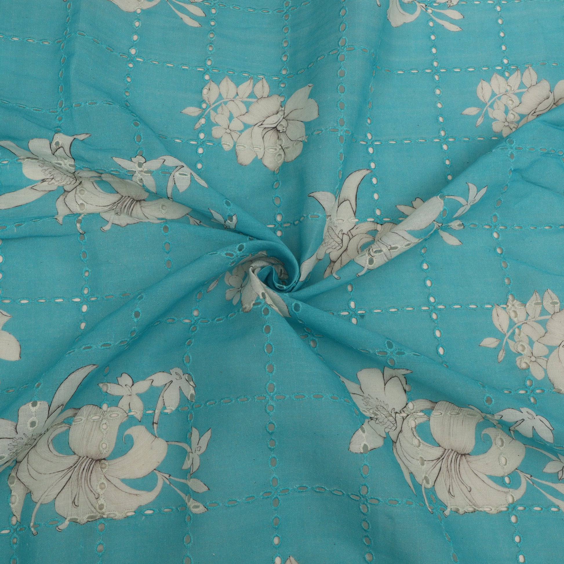 Turquoise fabric with white floral patterns