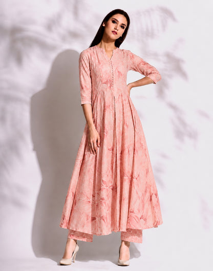 Woman wearing a pink traditional outfit against a white background