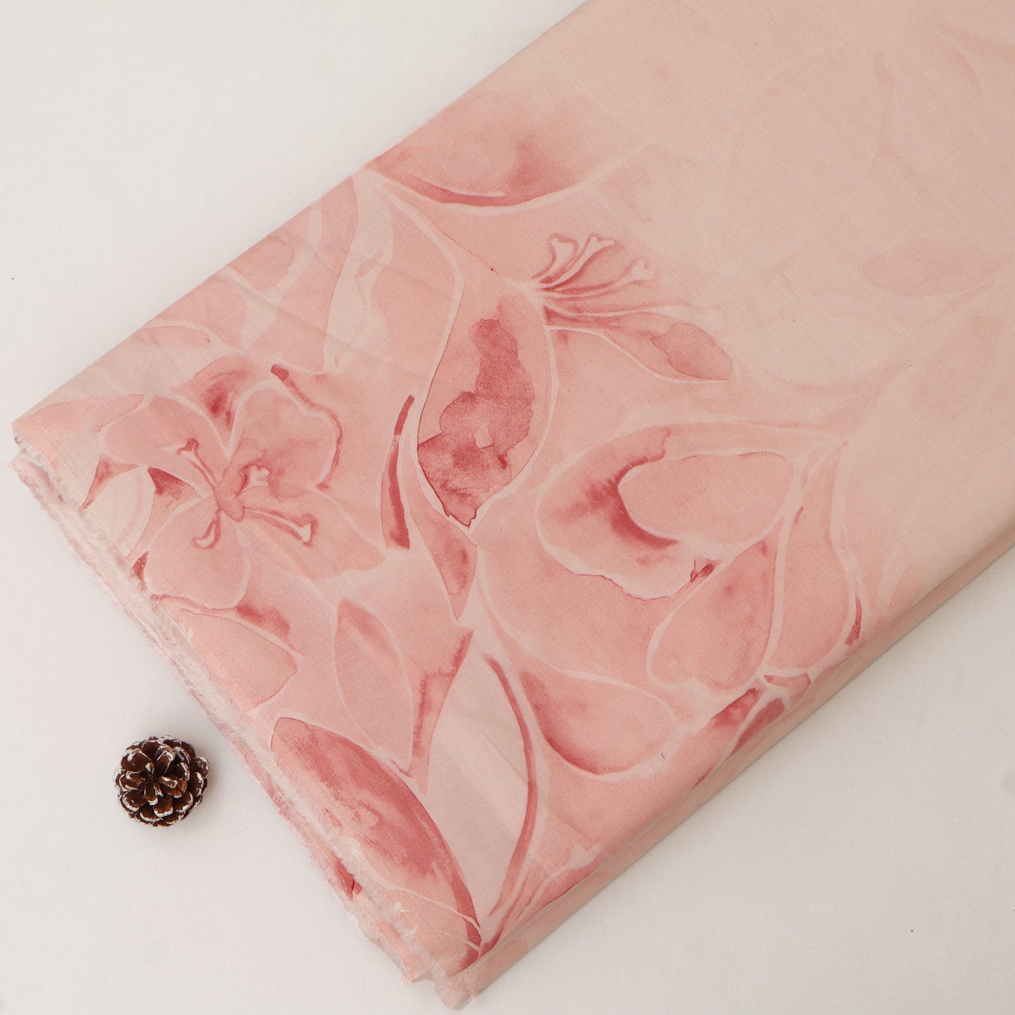Pink marbled soap bar with floral design on a white background